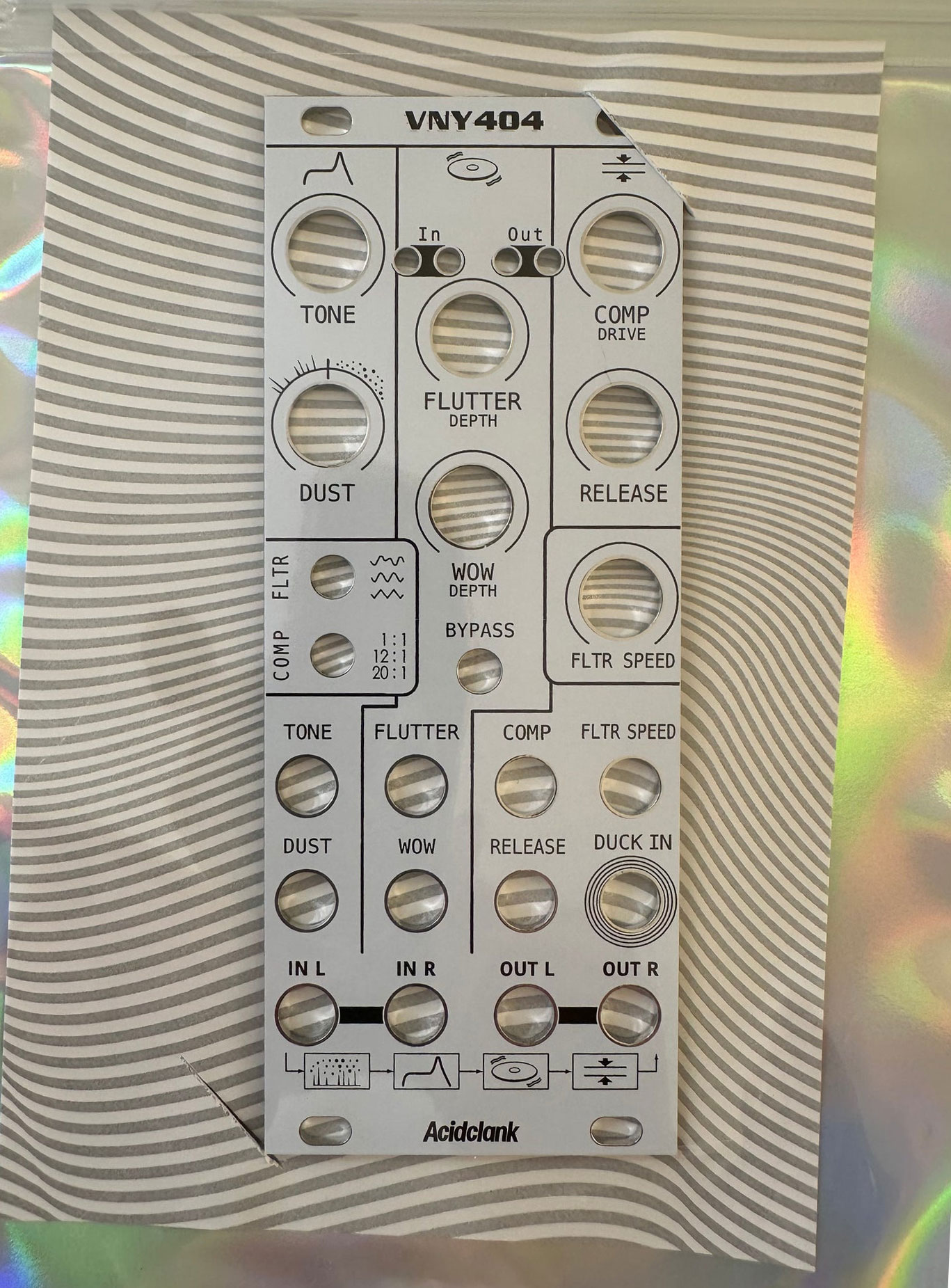 Front panel of a guitar effects pedal labeled Acidclank, with multiple knobs: Tone, Dust, Flutter, Depth, COMP DRIVE, WOW Depth, Release, Filter speed, and In/Out marks.