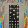 Acidclank Frgmnts front panel with knobs labeled Stutter, Time, Speed, Wash, Filter, Tape, and IN/OUT, mounted on a striped backing inside a holographic bag.