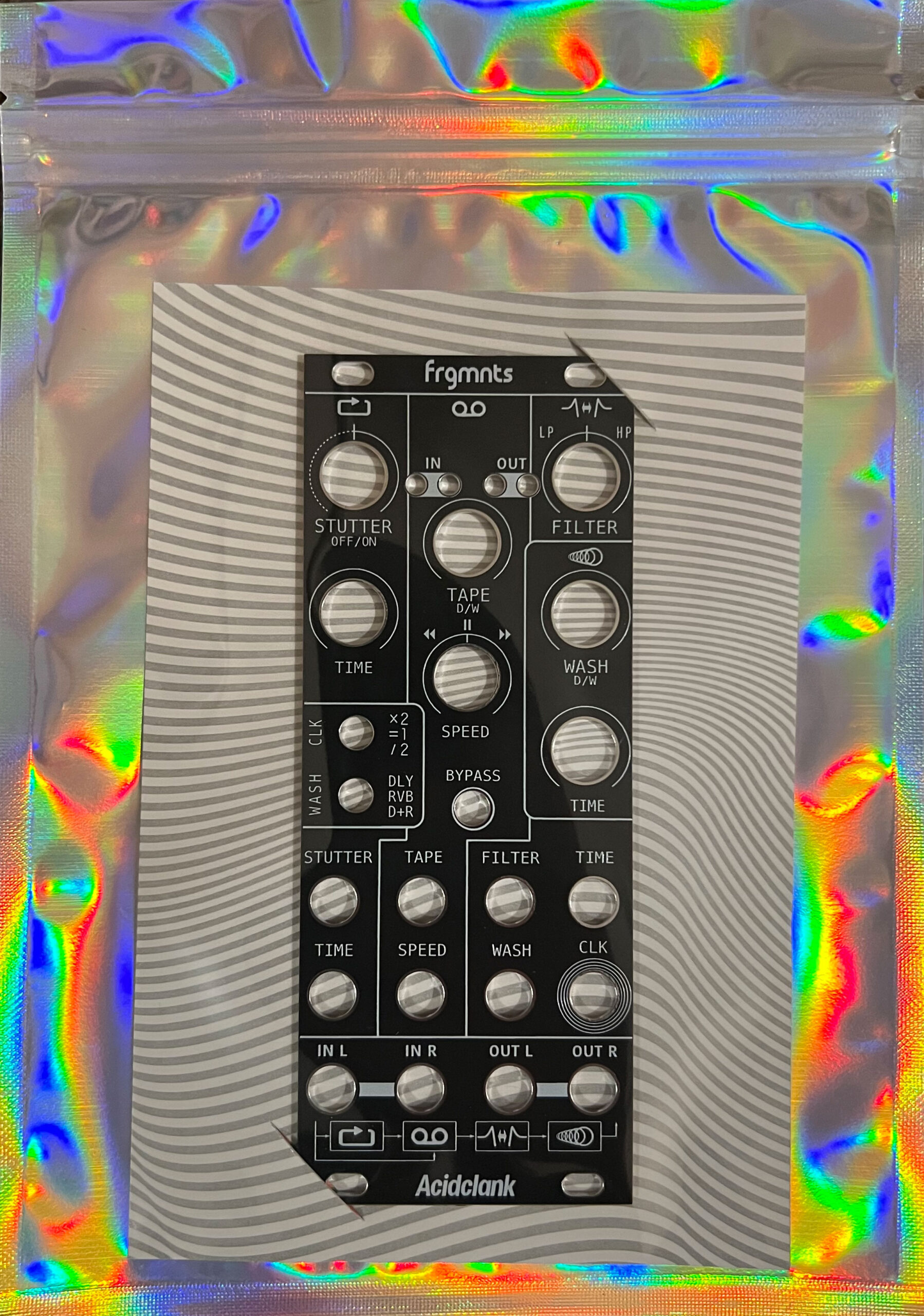 Acidclank Frgmnts front panel with knobs labeled Stutter, Time, Speed, Wash, Filter, Tape, and IN/OUT, mounted on a striped backing inside a holographic bag.